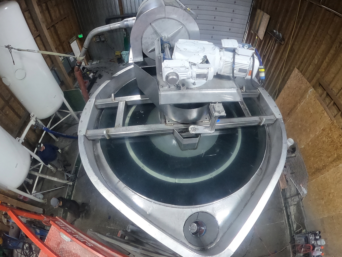 A Water-Re solids extraction system being built inside the Burley shop, seen from above with the auger drive mounted on its cross frame